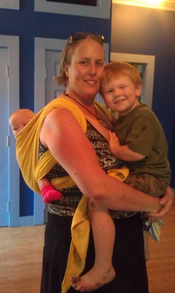 Wearing Baby on Back and Holding Toddler