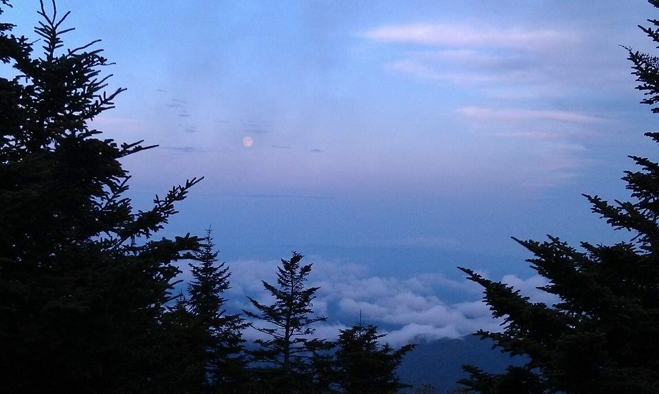 Back Wrap Cross Carry in front of the moon over Mt Mitchell North Carolina